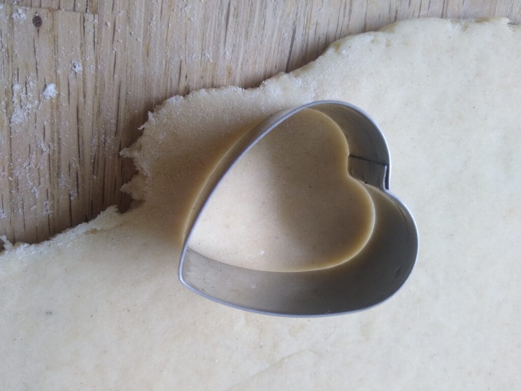 About - This is the Magic Behind Dinky Bakers! Heart shaped biscuit cutter on dough. Children