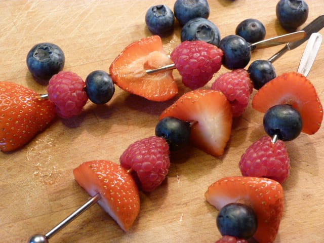 Fine motor activity, threading fruit onto a stick. Dinky Bakers.