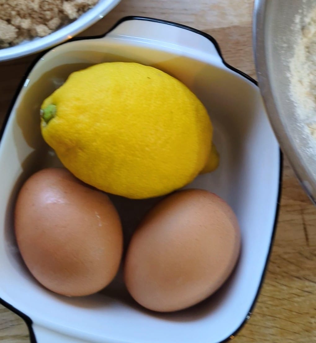 Eggs and a lemon in a bowl, ready for baking