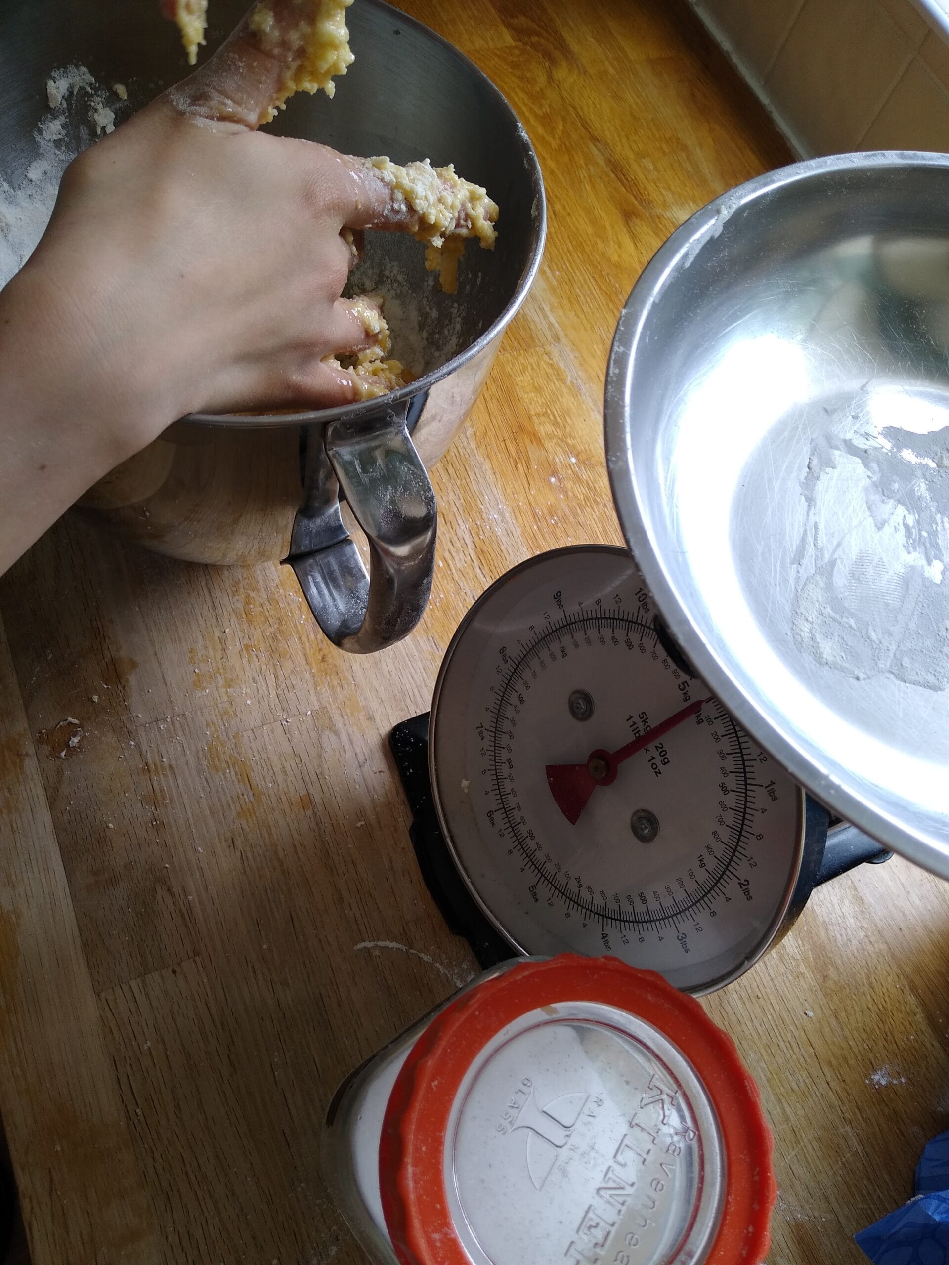 Child baking and measuring. Practising fractions and counting while baking with Dinky Bakers. Maths in the Kitchen.