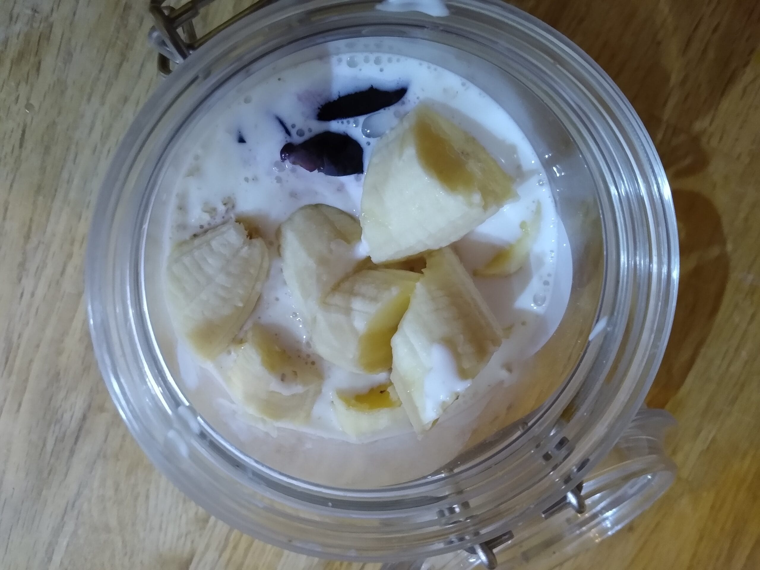 A jar of overnight oats with fruit and yoghurt, ready to eat for breakfast